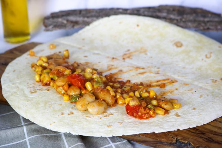 Vegan taquitos filling on tortilla