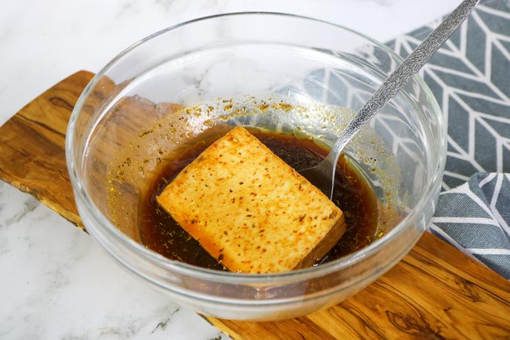 Vegan tofu burgers dipped in marinade